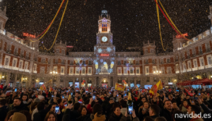 The famous clock tower at Puerta del Sol in Madrid Spain at night during New Year's Eve celebrations, illuminated facade w...